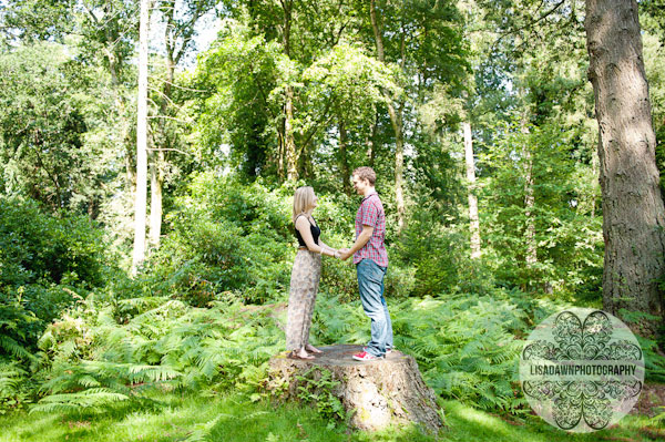 Creative photography of an engaged couple standing in the forest