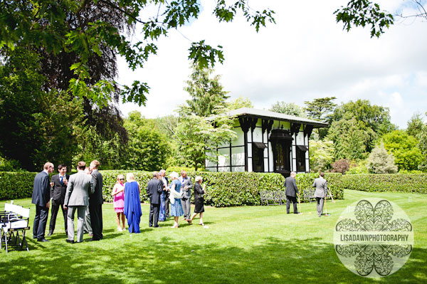 Wedding guests chatting in the gardens