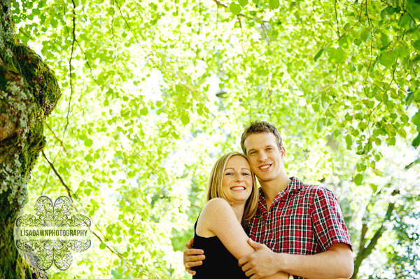 Creative portraits of an engaged couple under a tree