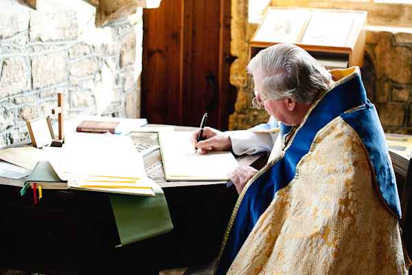 Vicar signing the register