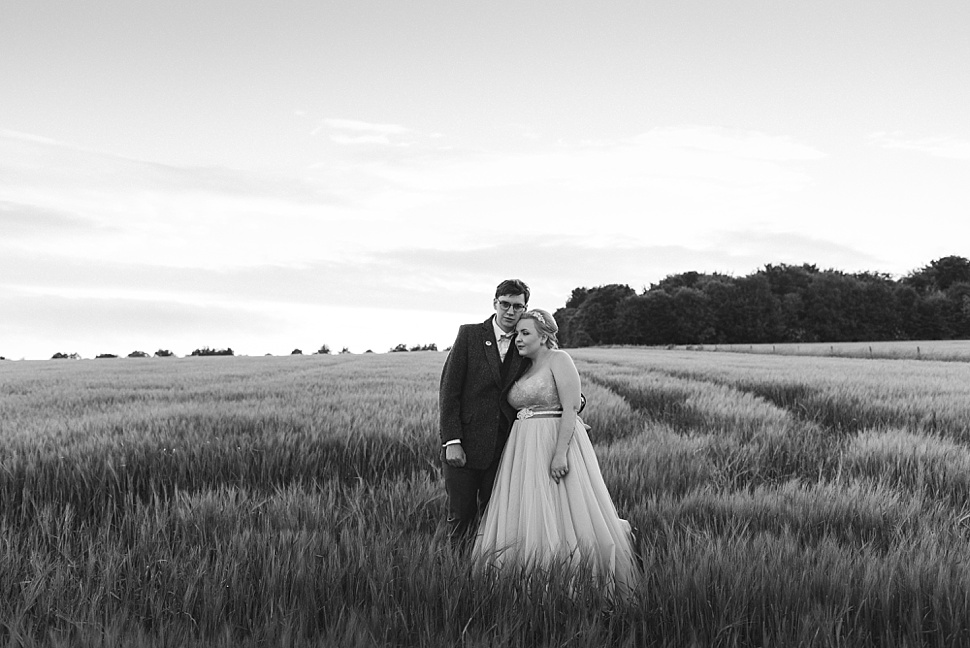 Bride and groom in field