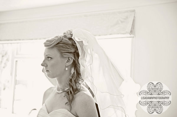 bride putting on veil