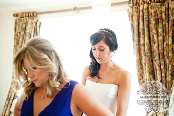 Bridesmaid getting into her dress