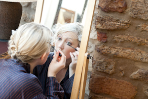 Bride putting make up on