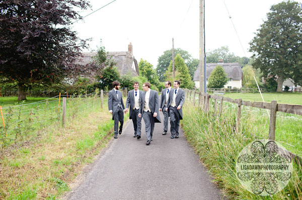 groomsmen walking down country lane