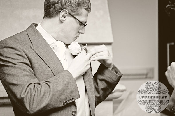 Groom putting on buttonhole