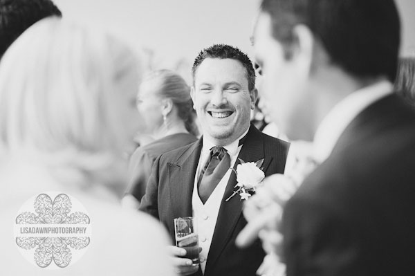 Groom laughing at reception