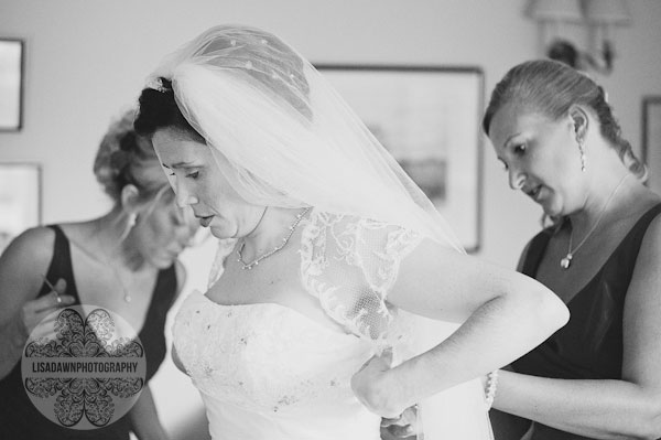 putting on the wedding dress