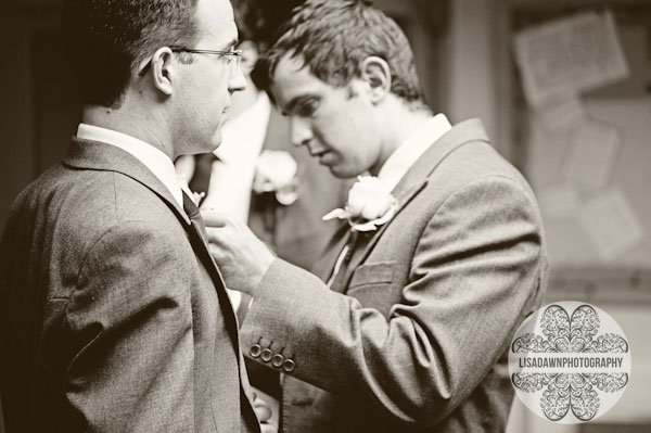 Ushers putting on buttonhole