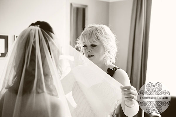 bridesmaid altering the veil