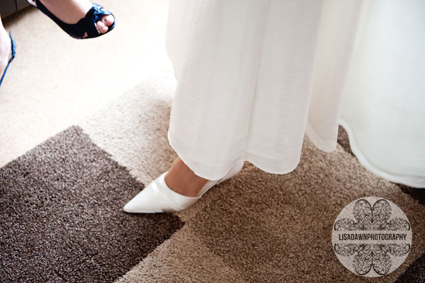 putting on wedding shoes