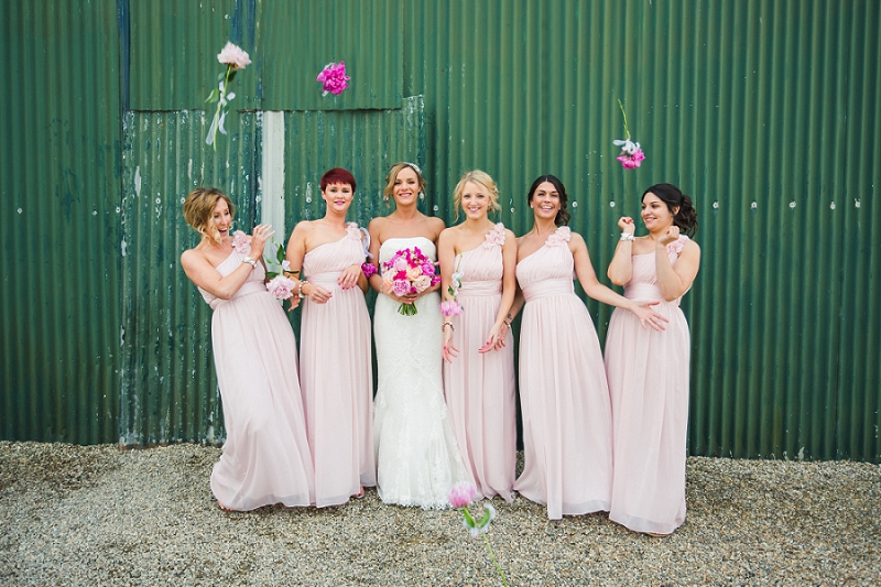 fun bridesmaids with flowers group photo