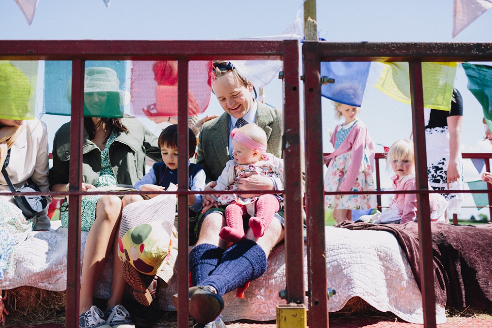 guests on wedding tractor